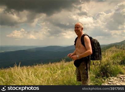 Poland.Western Carpathians called Bieszczady.Tourist ,hiker standing on the path to the mountain .One man .top.Summer.Horizontal view.