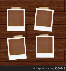 Polaroids over a wooden backgound