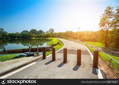 Pole blocking car from entry,Vehicle access barrier at Along road landscape view in Ang Kaew Chiang Mai University Forested Mountain blue sky background with white clouds, Nature Road