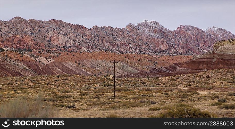Pole in a desert with mountain range in the background, Utah, USA