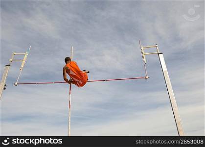 Pole vaulted in mid-air, low angle view