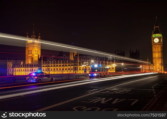 Police, ambulance emergency vehicles at night on Westminster Bridge by Big Ben, Houses of Parliament, London, England