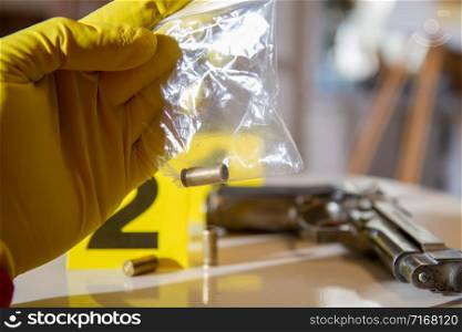 police inspector collects evidence of used cases at the crime scene. Evidence crime scene
