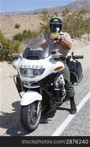 Police man using speed gun on road