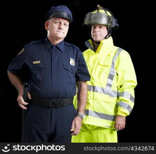 Police officer and firefighter, serious expressions, against a black background.