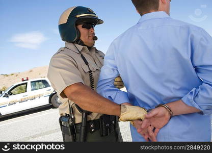 Police officer arresting driver