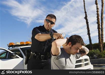 Police Officer Arresting Young Man