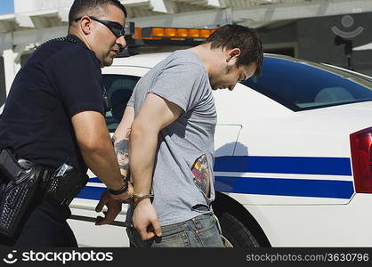 Police Officer Arresting Young Man