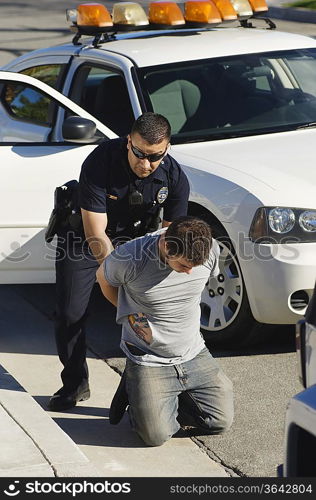 Police Officer Arresting Young Man