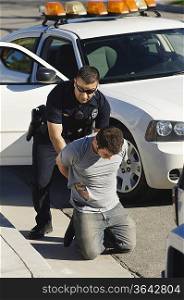 Police Officer Arresting Young Man