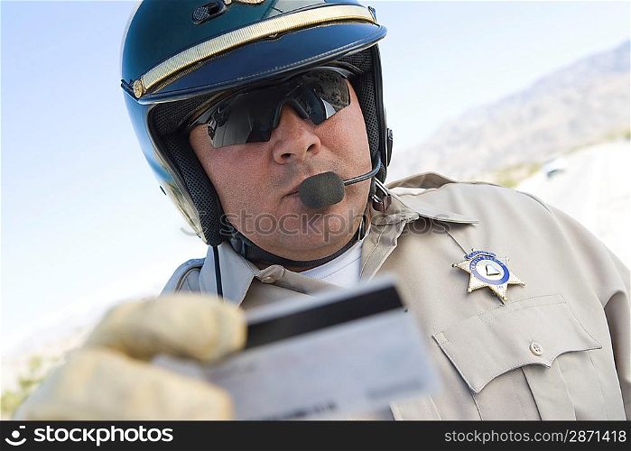 Police officer checking driver&acute;s ID