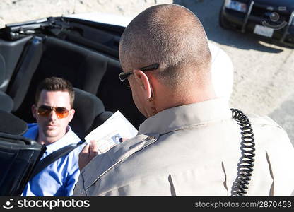 Police officer checking on driver