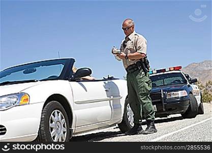 Police officer checking on driver in desert