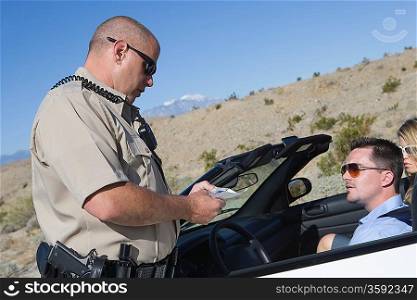 Police officer checking on driver in desert