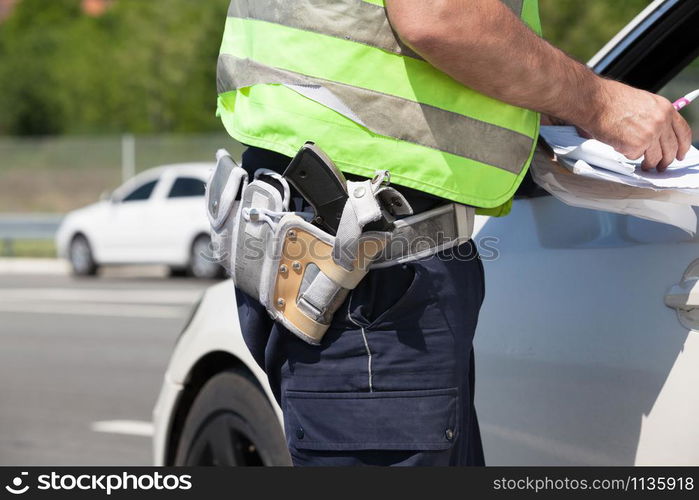 Police officer is writing a speeding ticket