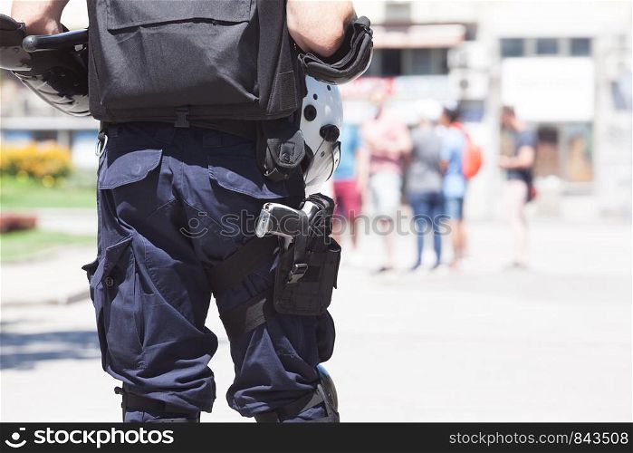 Police officer on duty, blurred people in the background