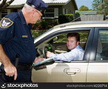 Police officer pulling over a drunk driver. The driver is holding a beer and looking embarassed.