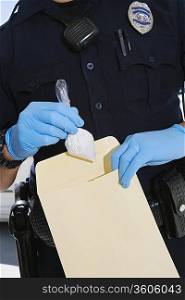 Police Officer Putting Cocaine in Evidence Envelope