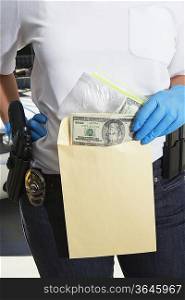 Police Officer Putting Money in Evidence Envelope