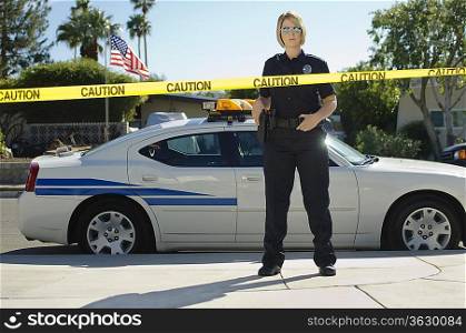 Police Officer Standing Behind Police Tape