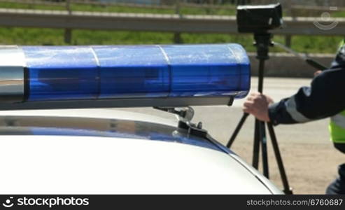 Police Officer Using Radar Speed Gun