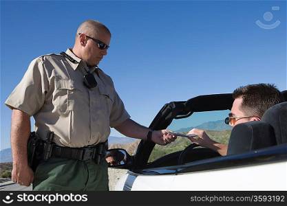 Policeman giving driver speeding ticket