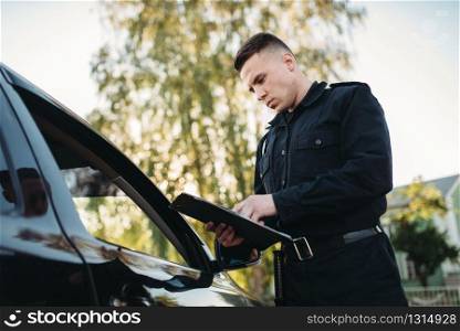 Policeman in uniform writes a fine to female driver. Law protection, car traffic inspector, safety control job. Policeman in uniform writes fine to female driver