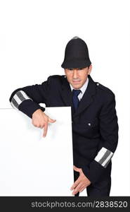 Policeman pointing to advertising board