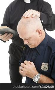 Policeman prays and receives a blessing from his priest or minister.