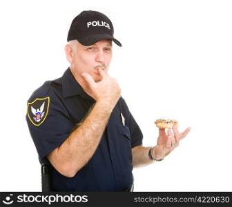 Policeman with a donut, licking icing off his fingers. Isolated on white.