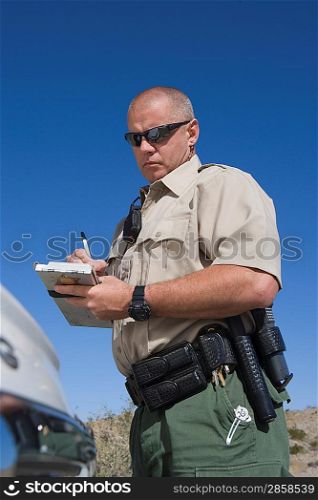 Policeman writing speeding ticket