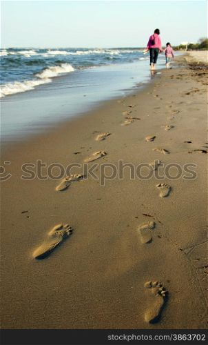 Polish coast and mom and daughter girl walk - Footprint