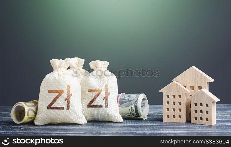 Polish zloty money bags and residential buildings figures. Financing the construction of new settlements. ortgage loan. Taxes. Municipal budget management. Investments in real estate.