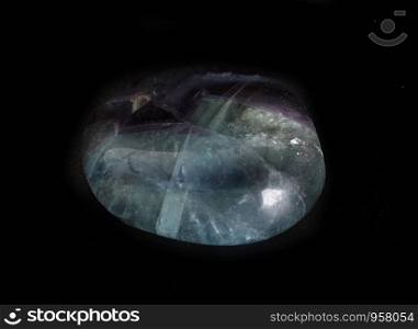 polished fluorite in front of black background