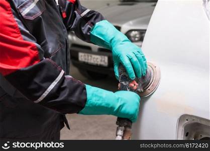 Polishing the car with power buffer machine , closeup