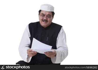 Politician reading document over white background