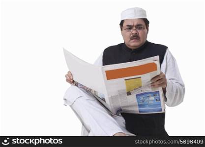 Politician reading newspaper with shocked expression