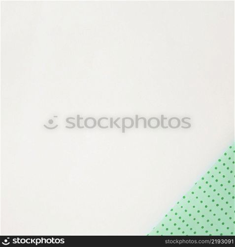 polka dot green wrapped paper corner white background