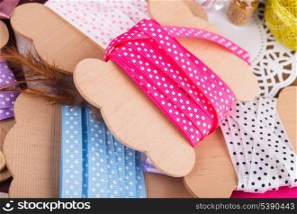 Polka dot ribbon on wooden vintage bobbins for scrapbooking