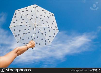 Polka dot umbrella with blue sky