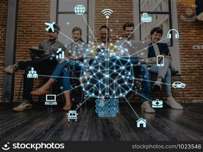 Polygonal brain shape of an artificial intelligence with various icon of smart city Internet of Things Technology over Group Of Asian and Multiethnic people using the technology device in working loft