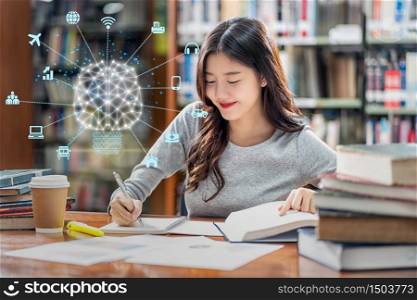 Polygonal brain shape of an artificial intelligence with various icon of smart city Internet of Things Technology over Asian young Student in casual suit reading the book in library of university