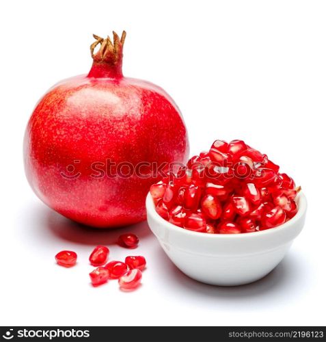 Pomegranate and seeds in ceramic bowl close-up macro studio shot. Pomegranate and seeds in ceramic bowl close-up