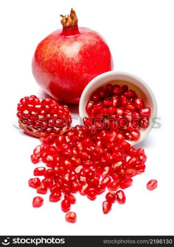 Pomegranate and seeds in ceramic bowl close-up macro studio shot. Pomegranate and seeds in ceramic bowl close-up