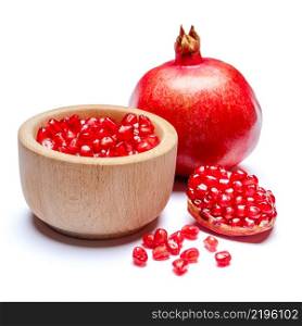 Pomegranate and seeds in wooden bowl close-up macro studio shot. Pomegranate and seeds in wooden bowl close-up