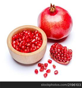 Pomegranate and seeds in wooden bowl close-up macro studio shot. Pomegranate and seeds in wooden bowl close-up