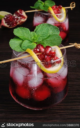 pomegranate drink with ice, a slice of lemon and mint