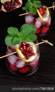 pomegranate drink with ice, a slice of lemon and mint