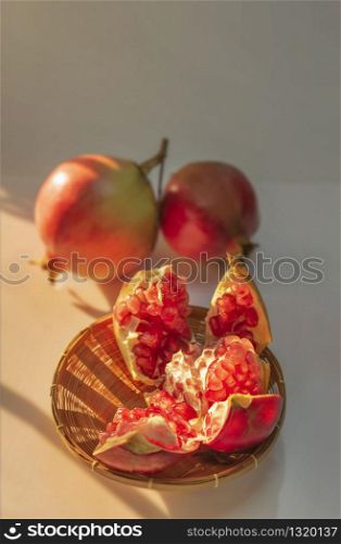 Pomegranate Fruit and wooden basket with sunlight. Fresh Pomegranate Fruit