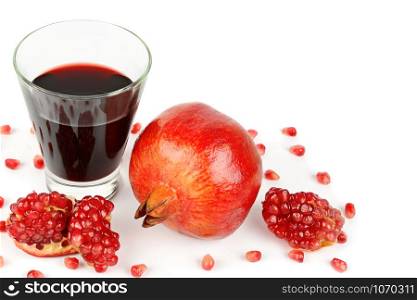 Pomegranate juice in a glass and ripe pomegranate. Isolated on white background. Free space for your text.